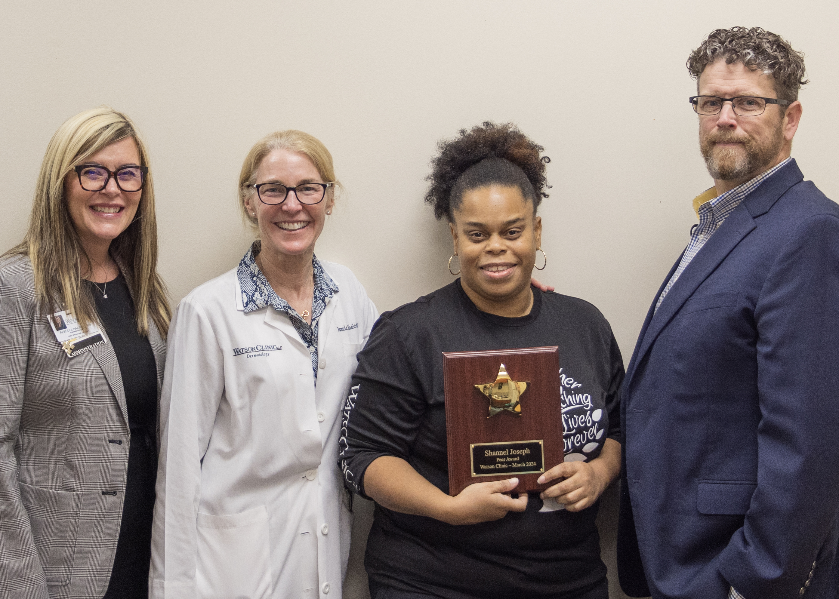 Shannel Joseph (center) is pictured in the attached photo proudly displaying her PEER Award plaque alongside Watson Clinic Chief Operating Officer Rebecca Pacatte (far left), Bella Vista Building Dermatologist Pamela Sakalosky, MD (second from left), and Chief Executive Officer Jason Hirsbrunner (right). 